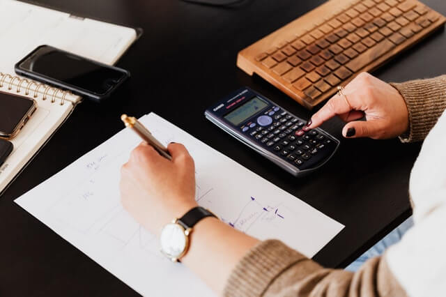 How do you know if an accountant is right for you? 5 clues to look for. crop woman using calculator and taking notes on paper